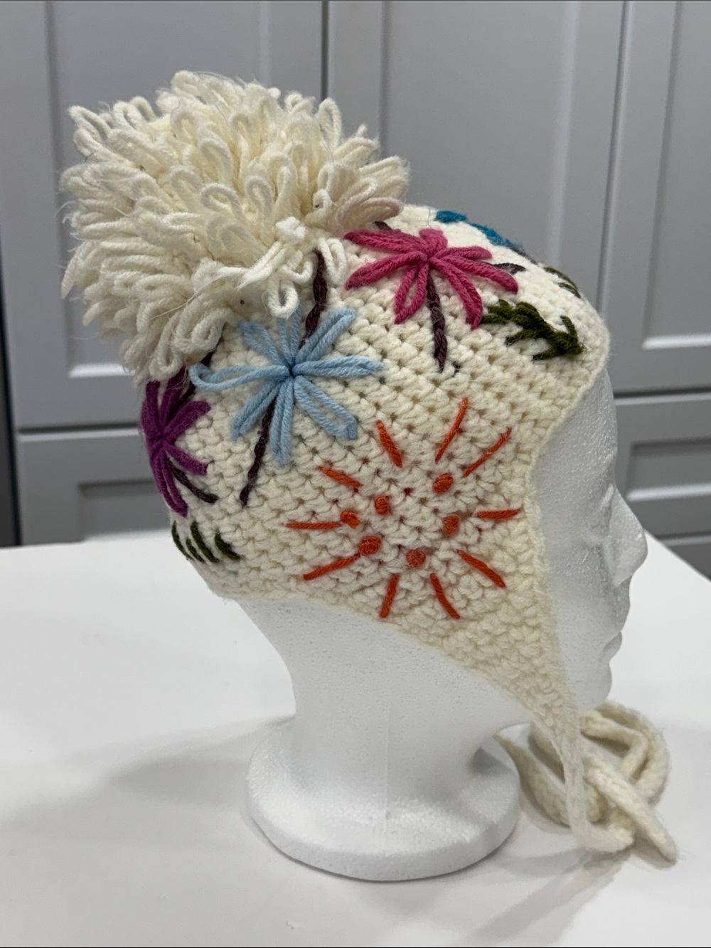 🌸 Girls’ Cozy Floral Hat with Ear Flaps & Ties — Cream with Colorful Details